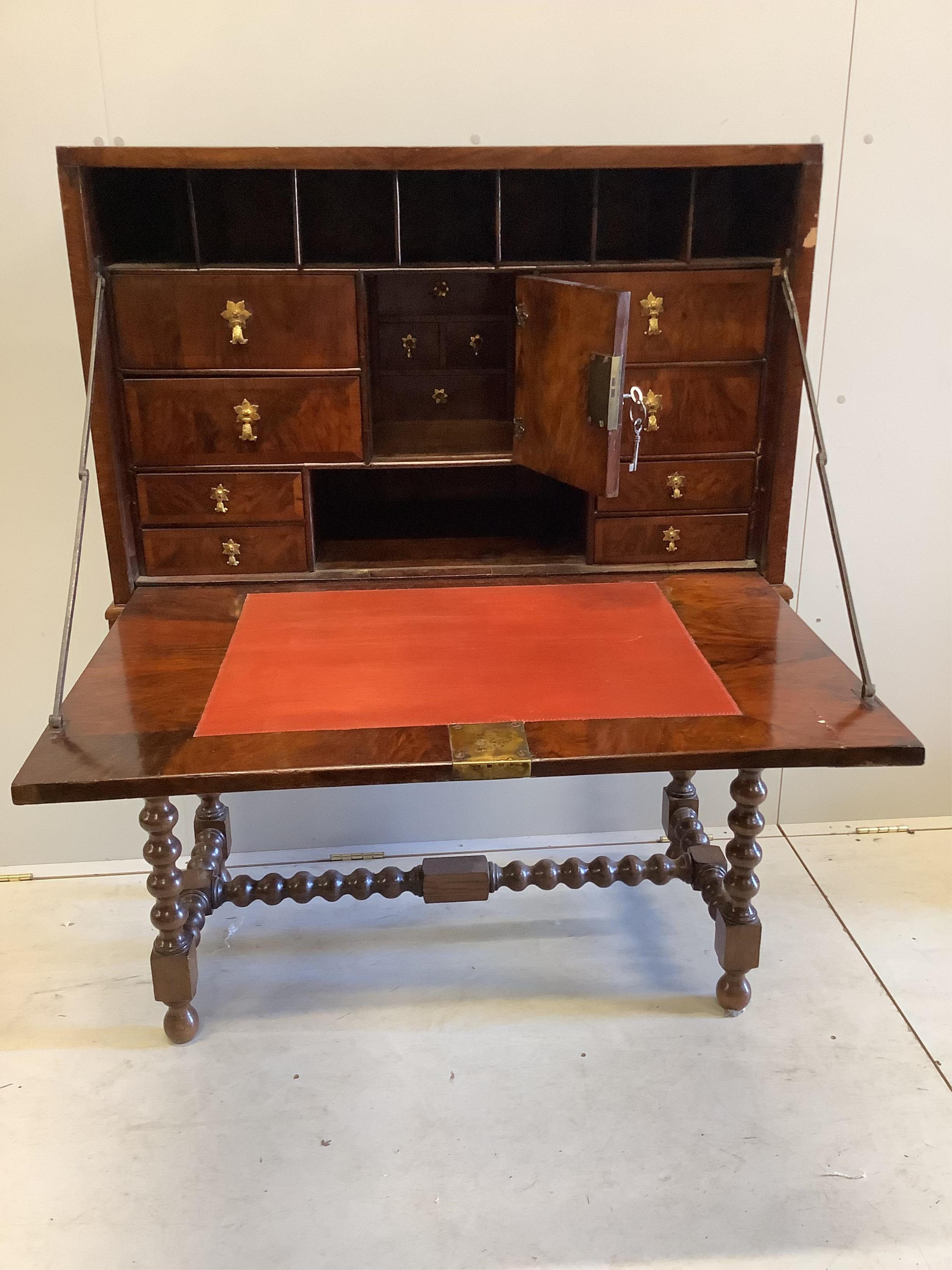 An 18th century walnut secretaire cabinet on later stand, width 91cm, depth 44cm, height 130cm. Condition - fair